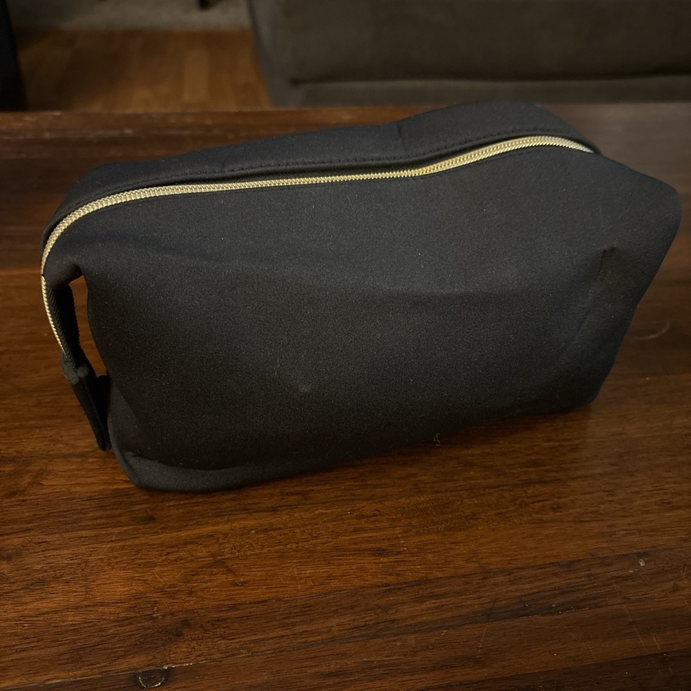 Tarte Cosmetics Black makeup bag with gold accents.